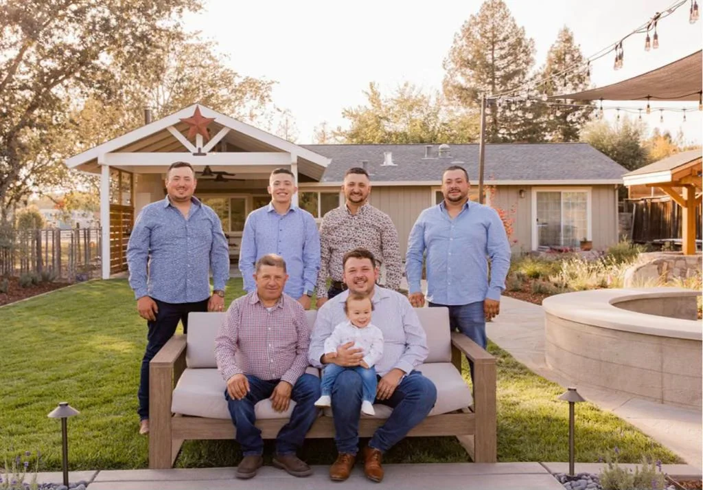 Three generations of the Highland family on a garden bench, a baby in the front row